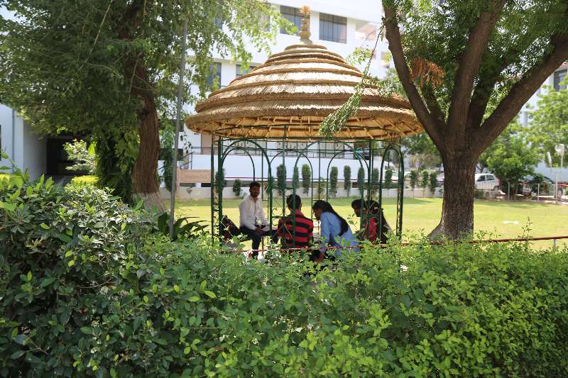 A building and the green grounds of the SKIT Jaipur campus